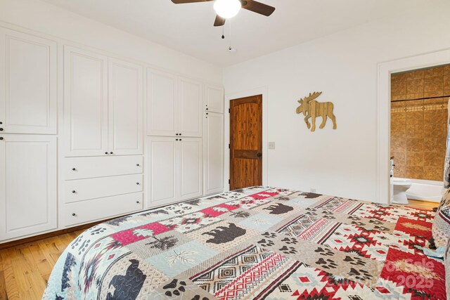 bedroom with a ceiling fan, light wood-style flooring, and ensuite bathroom