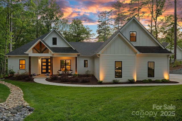 127 Holt Ln, Mooresville, NC 28117 - view of front of property with board and batten siding, a lawn, and roof with shingles