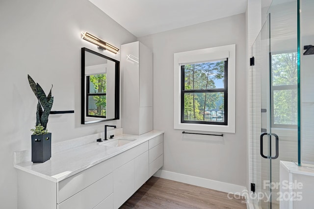 127 Holt Ln, Mooresville, NC 28117 - full bathroom with baseboards, a shower stall, wood finished floors, and vanity