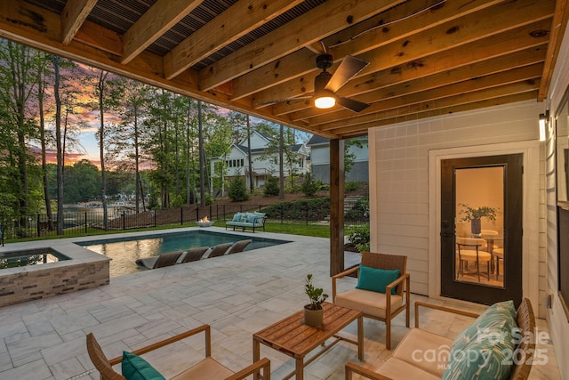 127 Holt Ln, Mooresville, NC 28117 - patio terrace at dusk featuring a fenced in pool, a ceiling fan, an in ground hot tub, and a fenced backyard