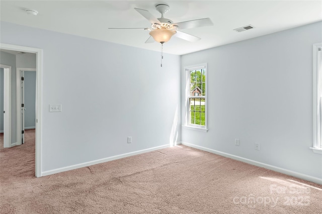 unfurnished room featuring baseboards, visible vents, carpet, and ceiling fan