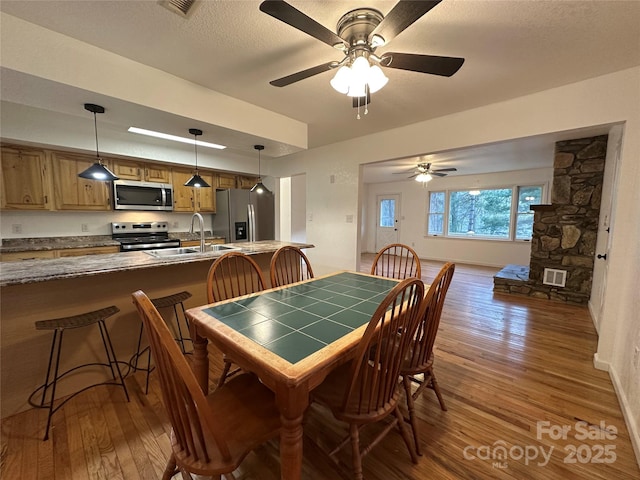 5381 State Highway 197 S Unit 3, Burnsville, NC 28714 - dining area featuring baseboards, wood finished floors, a textured ceiling, and ceiling fan