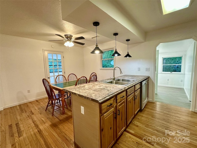 5381 State Highway 197 S Unit 3, Burnsville, NC 28714 - kitchen with stainless steel dishwasher, a sink, brown cabinetry, light wood finished floors, and decorative light fixtures
