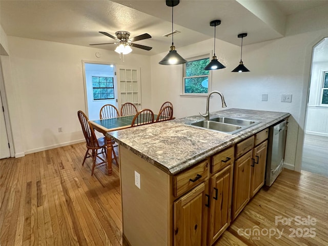 5381 State Highway 197 S Unit 3, Burnsville, NC 28714 - kitchen featuring dishwasher, brown cabinets, a sink, and light wood-type flooring
