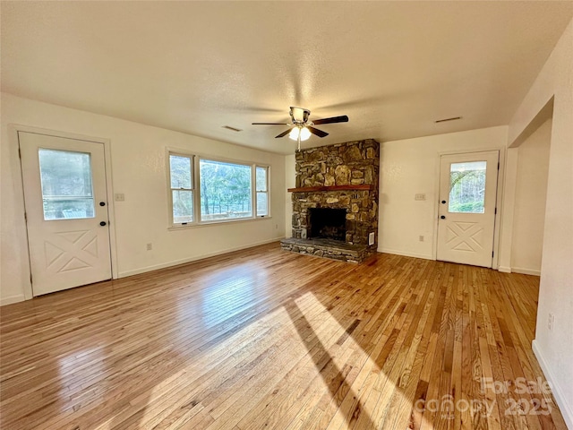 5381 State Highway 197 S Unit 3, Burnsville, NC 28714 - unfurnished living room featuring wood-type flooring, a healthy amount of sunlight, ceiling fan, and a fireplace