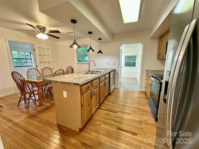 5381 State Highway 197 S Unit 3, Burnsville, NC 28714 - kitchen with light wood finished floors, a sink, arched walkways, appliances with stainless steel finishes, and ceiling fan