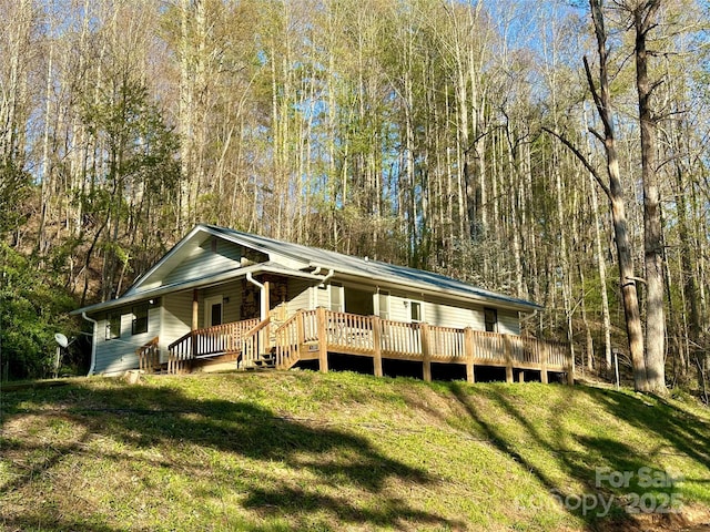 5381 State Highway 197 S Unit 3, Burnsville, NC 28714 - view of front of house with a porch, a front lawn, and a forest view
