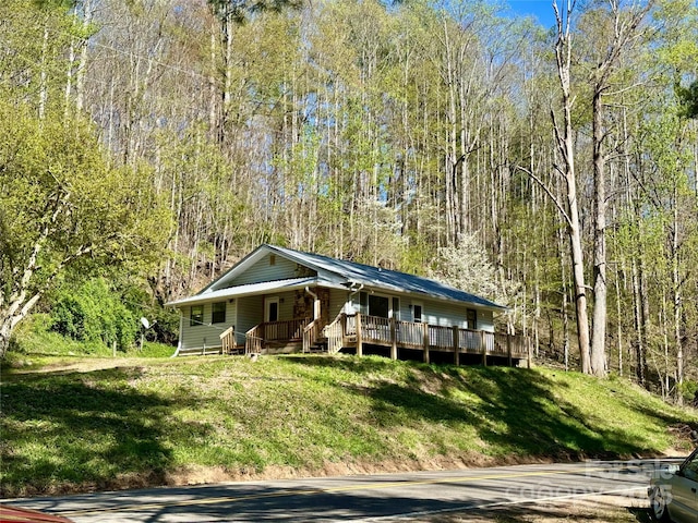5381 State Highway 197 S Unit 3, Burnsville, NC 28714 - view of front of property featuring a wooded view, a porch, and a front yard