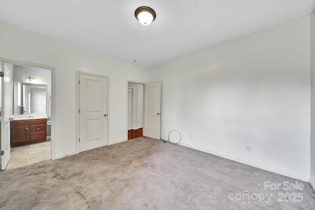 9862 Walkers Glen Dr NW, Concord, NC 28027 - unfurnished bedroom with light colored carpet, baseboards, and connected bathroom