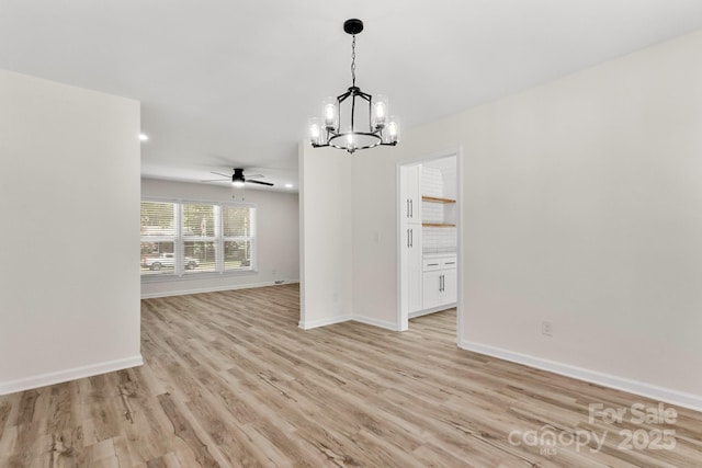 unfurnished dining area featuring light wood-style floors, baseboards, ceiling fan with notable chandelier, and recessed lighting
