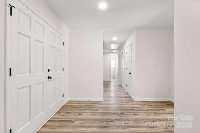 hall featuring recessed lighting, baseboards, and wood finished floors