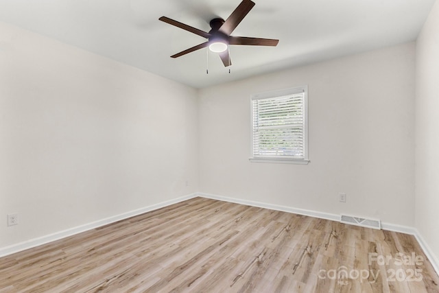 unfurnished room featuring a ceiling fan, baseboards, visible vents, and light wood-type flooring