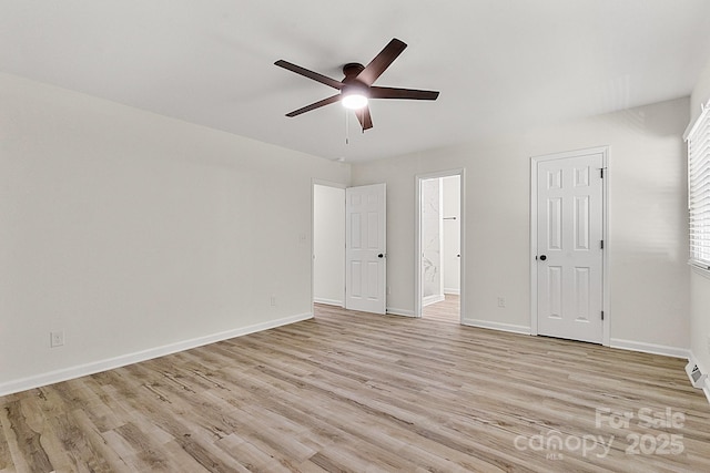 unfurnished bedroom with baseboards, light wood-style flooring, ceiling fan, and ensuite bath