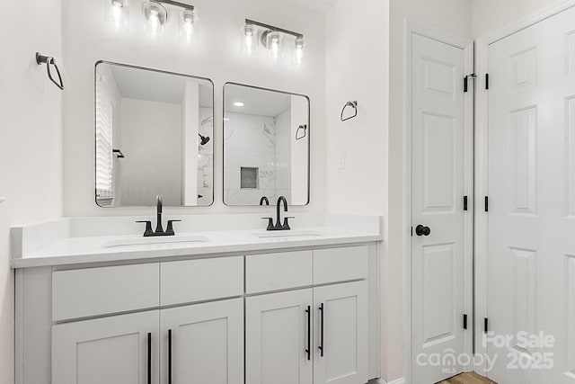full bathroom featuring double vanity, visible vents, a sink, and a stall shower