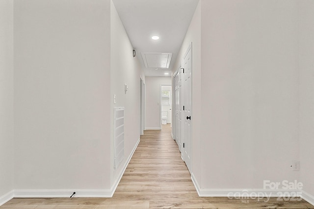 corridor with recessed lighting, baseboards, attic access, and light wood-type flooring