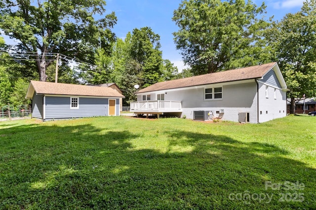 rear view of property with a yard, fence, cooling unit, and a wooden deck