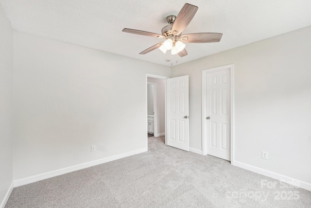 unfurnished bedroom with ceiling fan, carpet floors, a closet, and baseboards