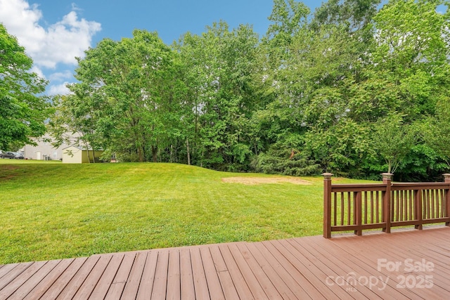 wooden deck featuring a yard