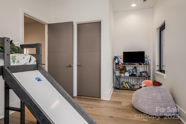 rec room featuring baseboards, visible vents, light wood finished floors, and recessed lighting