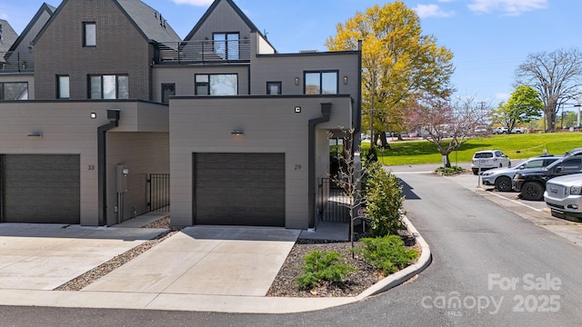 view of front of house with a gate, driveway, and a garage