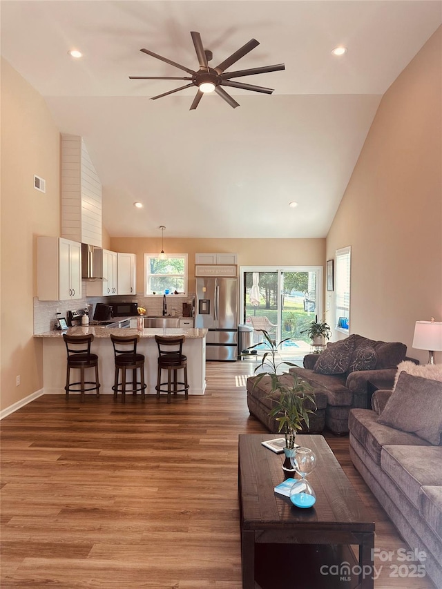 3121 Suffolk Dr, Shelby, NC 28152 - living area featuring high vaulted ceiling, light wood-style floors, ceiling fan, and recessed lighting