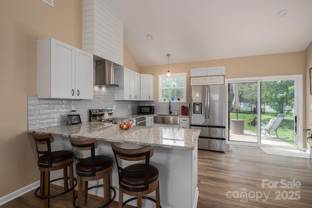3121 Suffolk Dr, Shelby, NC 28152 - kitchen with stainless steel appliances, wall chimney exhaust hood, a sink, a peninsula, and decorative backsplash