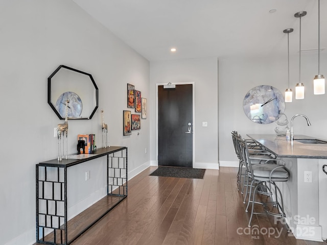 interior space with baseboards, recessed lighting, and dark wood-style floors