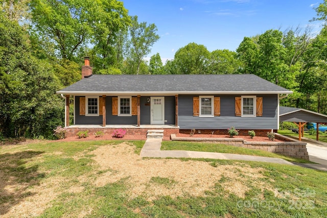 ranch-style house featuring roof with shingles, a porch, a front lawn, and a chimney