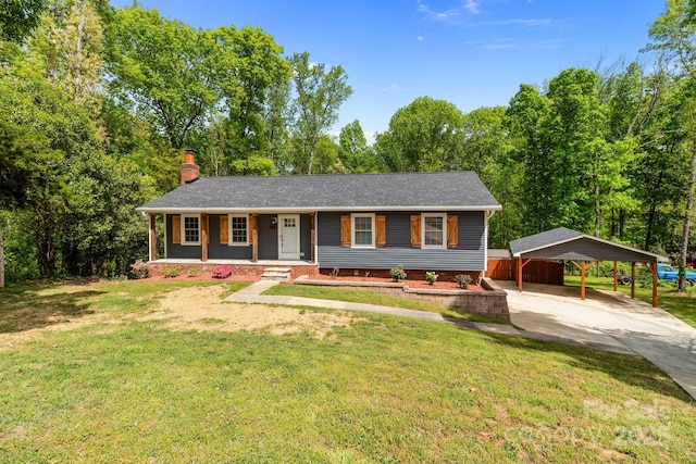ranch-style home with a detached carport, driveway, a porch, a chimney, and a front yard