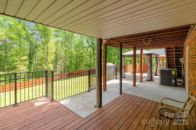 wooden deck with a fenced backyard, central AC, a patio, a lawn, and a gazebo