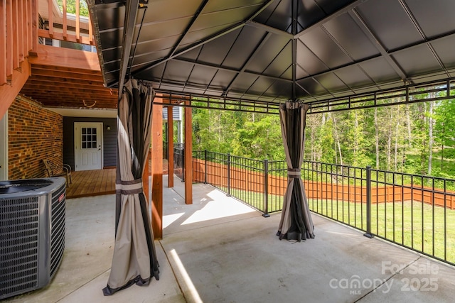 view of patio featuring fence, a gazebo, and central AC unit