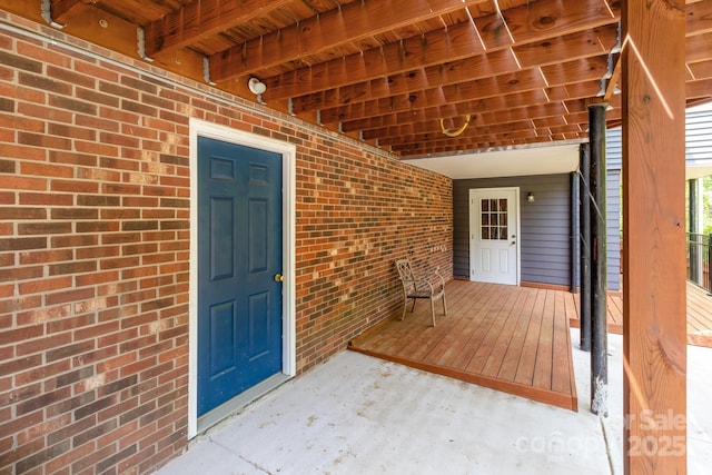 doorway to property featuring brick siding
