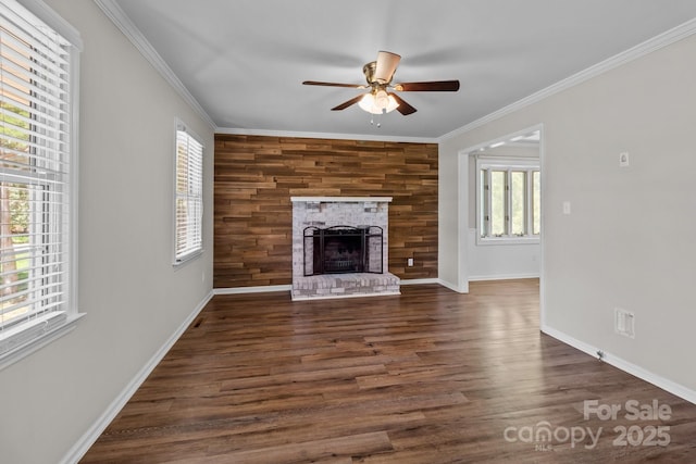 unfurnished living room with baseboards, a ceiling fan, crown molding, and a healthy amount of sunlight