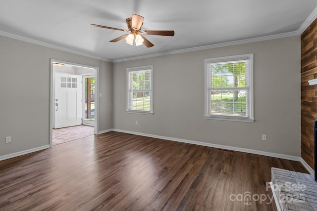 interior space featuring ceiling fan, baseboards, crown molding, and wood finished floors
