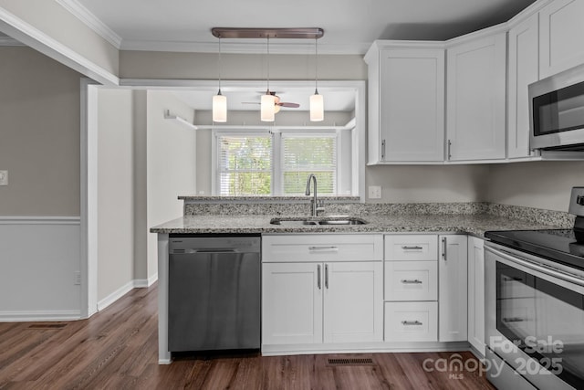 kitchen with stainless steel appliances, a sink, white cabinetry, and dark wood-style flooring