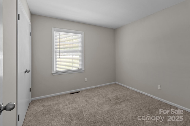 carpeted empty room with baseboards and visible vents