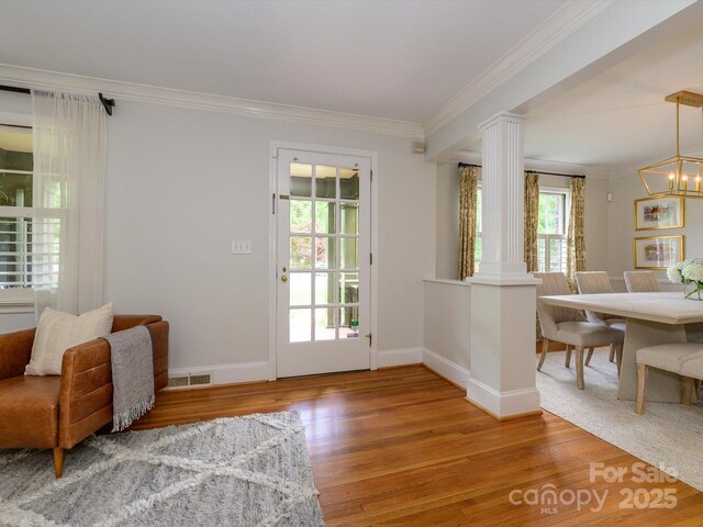 1596 Clayton Dr, Charlotte, NC 28203 - entryway with decorative columns, visible vents, crown molding, baseboards, and light wood-style floors
