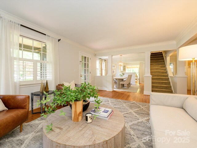 1596 Clayton Dr, Charlotte, NC 28203 - living area with ornamental molding, light wood-style flooring, stairs, and a healthy amount of sunlight