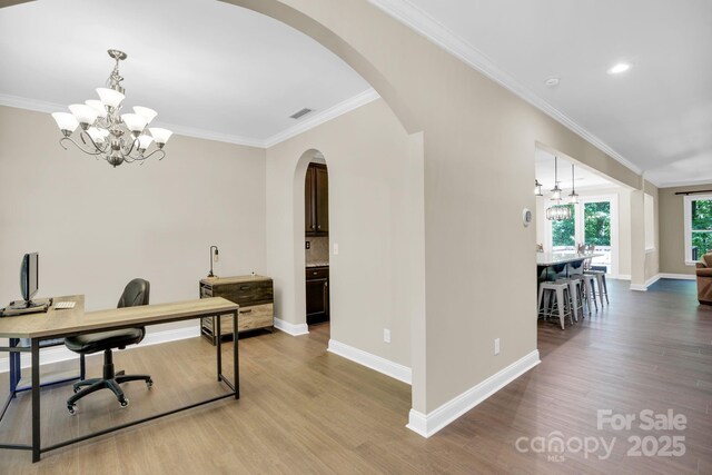 2417 Labelle Dr, Waxhaw, NC 28173 - office space with a chandelier, arched walkways, baseboards, wood finished floors, and crown molding