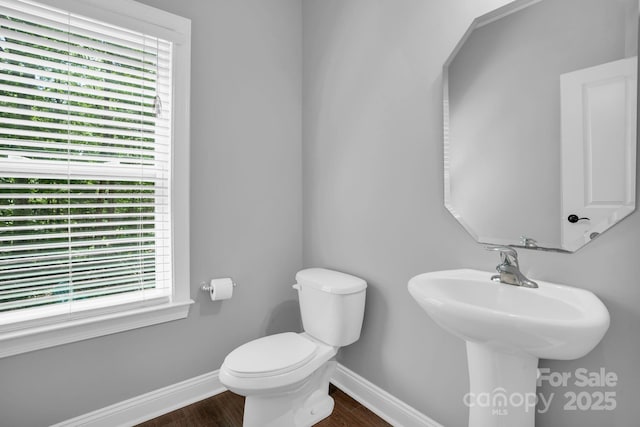 2417 Labelle Dr, Waxhaw, NC 28173 - half bath featuring baseboards, plenty of natural light, wood finished floors, and toilet