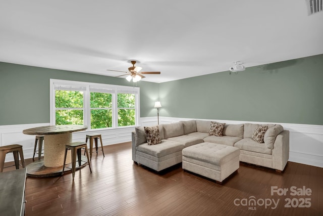 2417 Labelle Dr, Waxhaw, NC 28173 - living area featuring wainscoting, ceiling fan, a decorative wall, and dark wood-type flooring