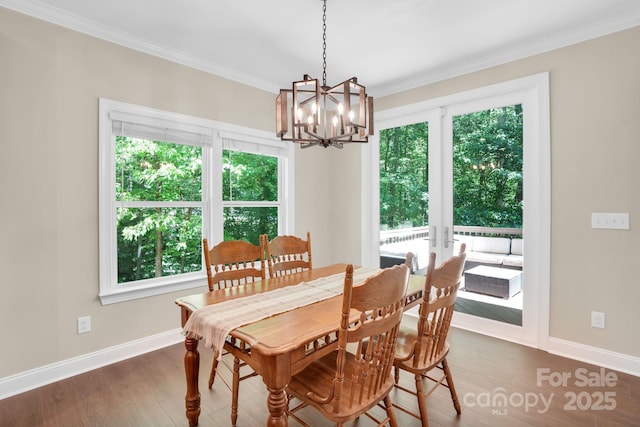 2417 Labelle Dr, Waxhaw, NC 28173 - dining space with healthy amount of natural light, a chandelier, wood finished floors, and ornamental molding