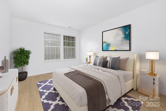 6523 Clavell Ln Unit I, Charlotte, NC 28210 - bedroom featuring baseboards and light wood-style flooring