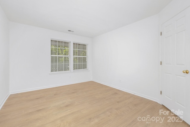 6523 Clavell Ln Unit I, Charlotte, NC 28210 - unfurnished room featuring baseboards, visible vents, and light wood-type flooring