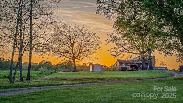 153 Coachman Loop, Statesville, NC 28625 - view of home's community with a lawn, a detached garage, and driveway