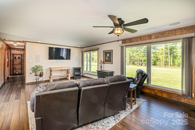 153 Coachman Loop, Statesville, NC 28625 - living area featuring wood walls, dark wood-style floors, ceiling fan, crown molding, and baseboards