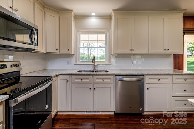 153 Coachman Loop, Statesville, NC 28625 - kitchen with appliances with stainless steel finishes, a sink, healthy amount of natural light, and dark wood-style flooring