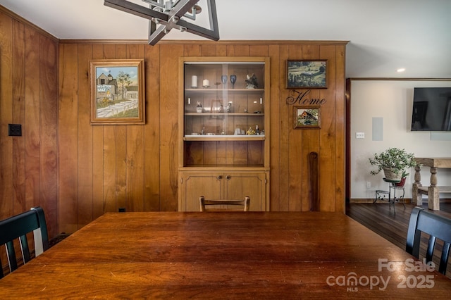 153 Coachman Loop, Statesville, NC 28625 - dining space with wooden walls, wood finished floors, and crown molding