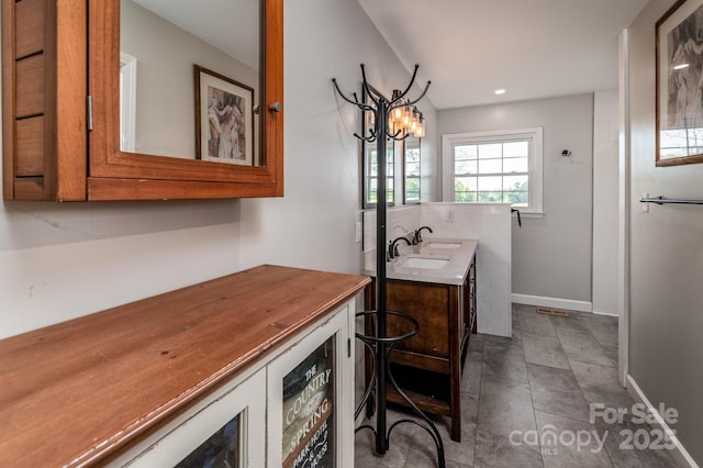 153 Coachman Loop, Statesville, NC 28625 - full bath featuring vanity, a chandelier, baseboards, and stone finish floors