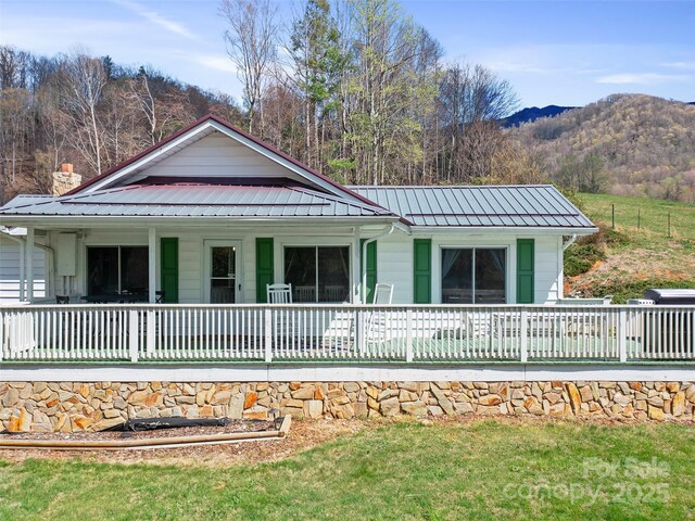 173 Odoms Chapel Rd, Bakersville, NC 28705 - view of front of house with a front lawn, a mountain view, a porch, and metal roof